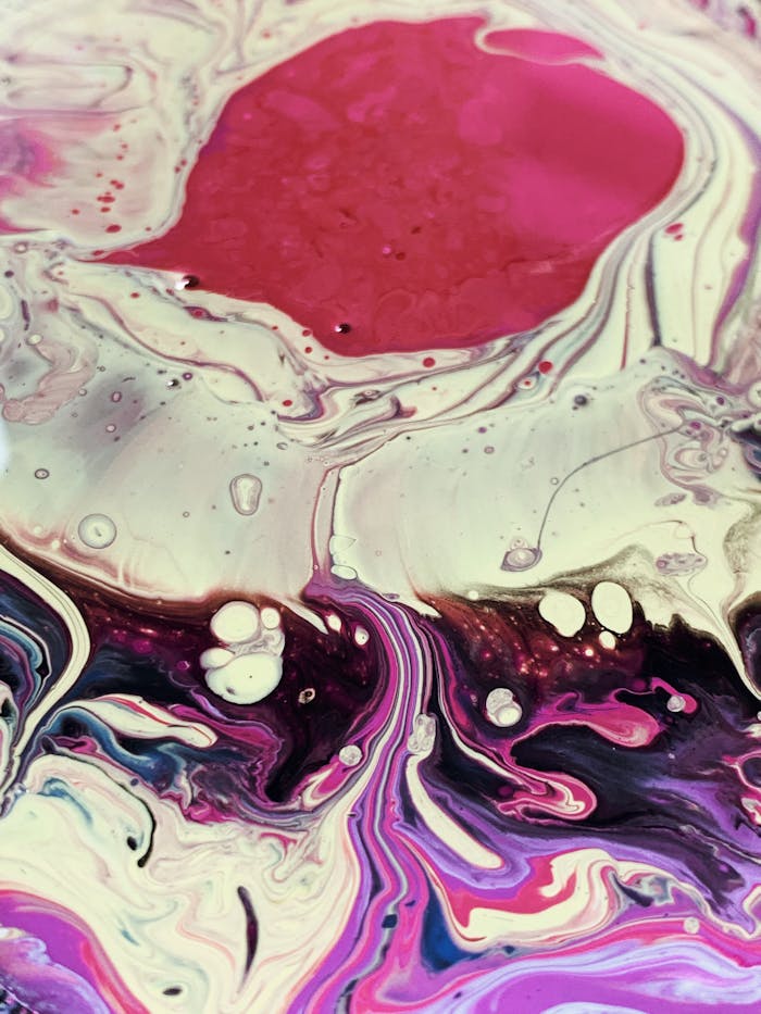 Eye-catching fluid art with bold pinks and purples creating a vivid abstract design.