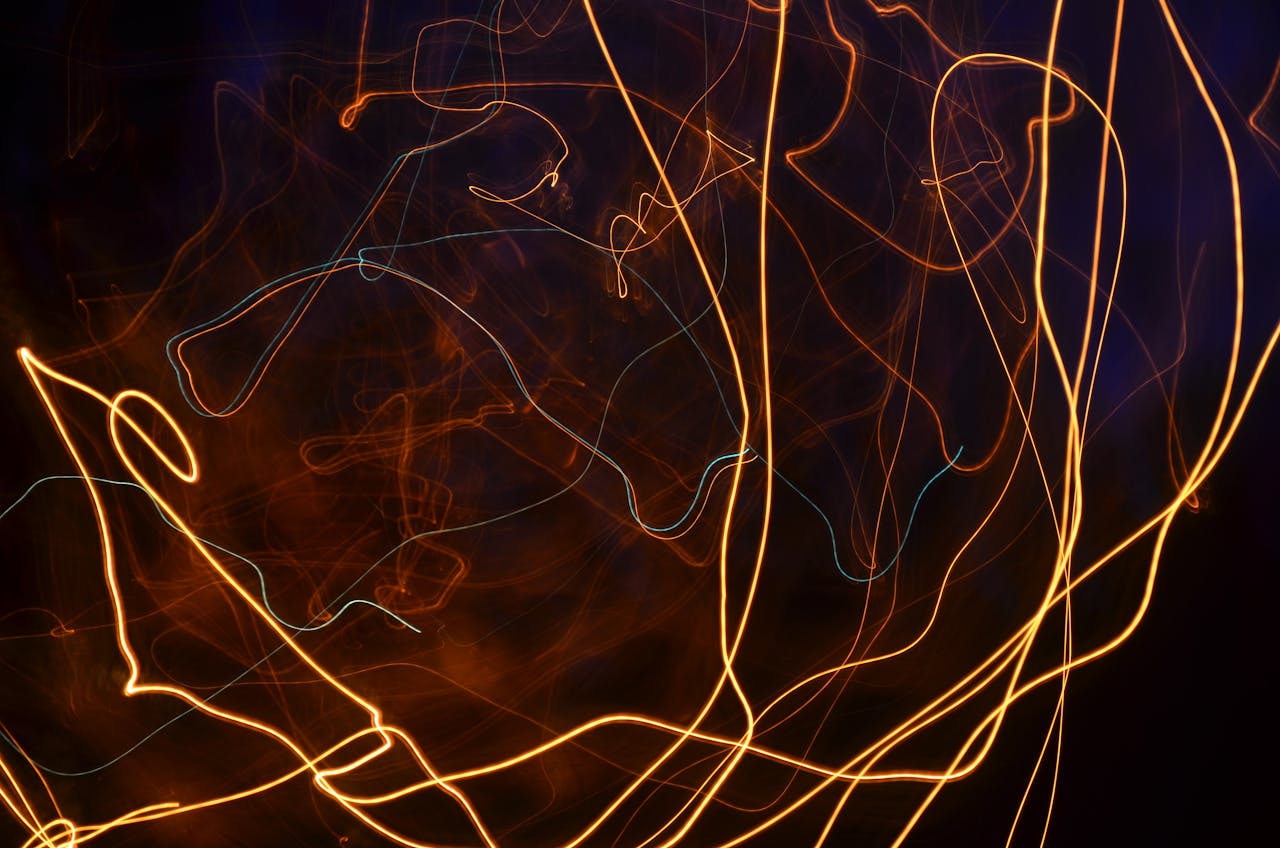 Dramatic display of vibrant light trails against a dark background captured with long exposure technique.